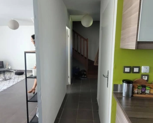 Vue du couloir avant les travaux avec une porte blanche et un espace clos.